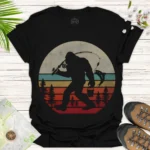 Bigfoot Fishing Graphic T-Shirt — Retro Sunset Sasquatch Tee - black