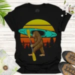 Bigfoot Kayaking T-Shirt — Retro Sunset Sasquatch Canoe Shirt for Outdoor Lovers