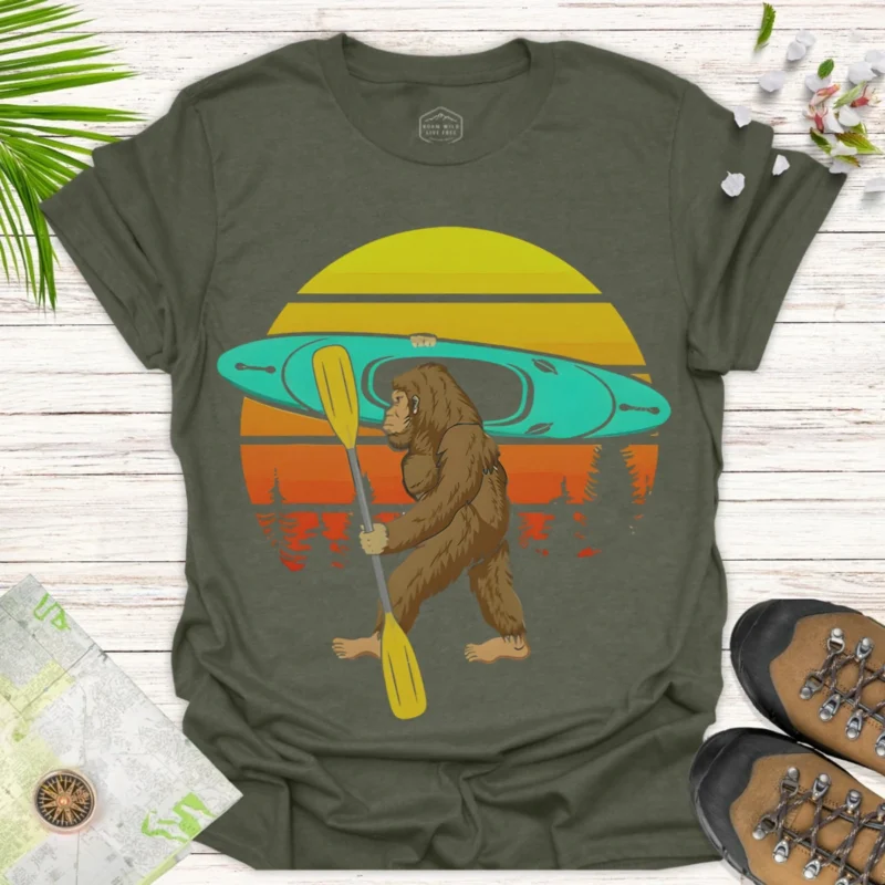 Bigfoot Kayaking T-Shirt — Retro Sunset Sasquatch Canoe Shirt for Outdoor Lovers - green